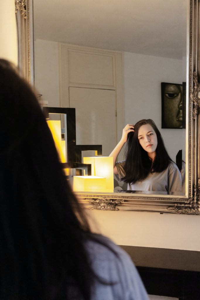 Woman looking in mirror